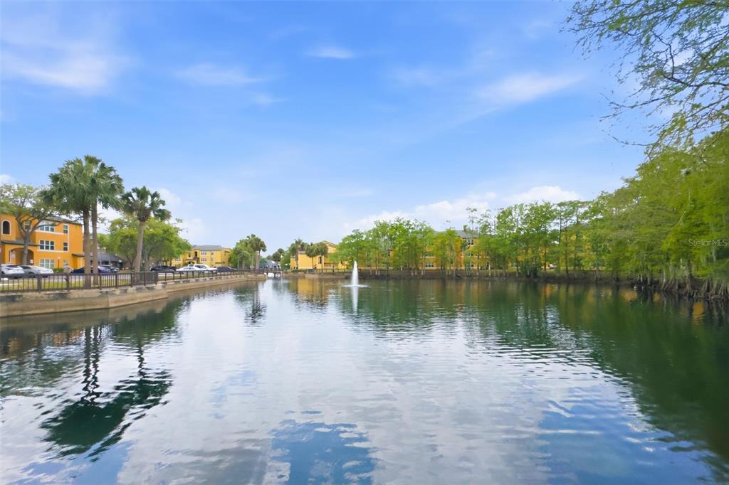 4532 Commander Drive, Unit 2132 Orlando, FL 32822 - Photo 23 of 26 a view of a lake with houses in the back