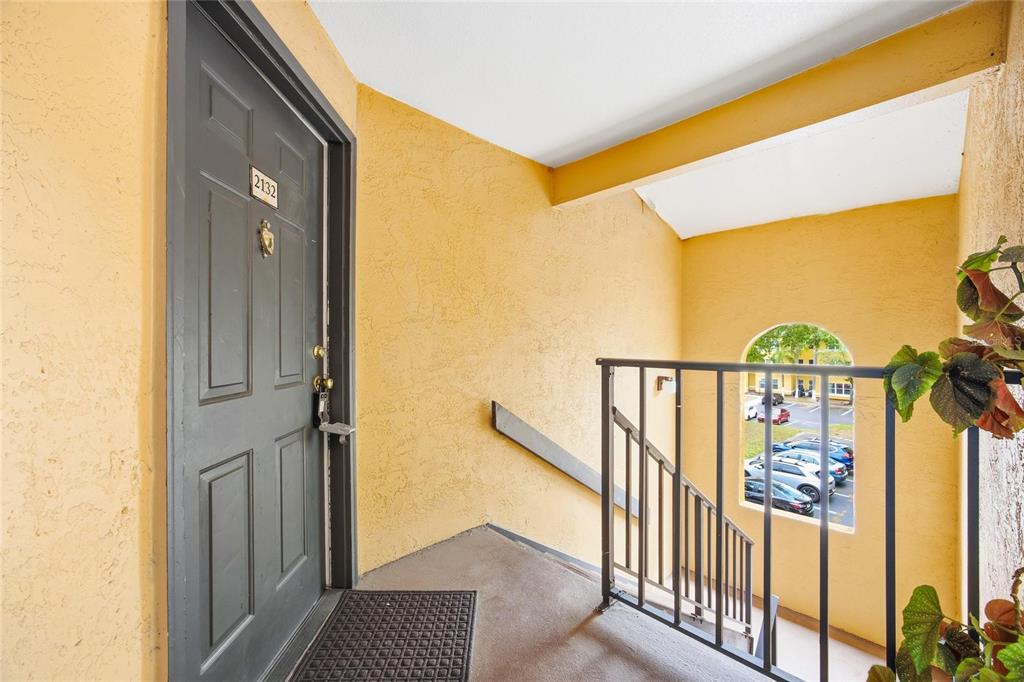 4532 Commander Drive, Unit 2132 Orlando, FL 32822 - Photo 4 of 26 a view of a balcony with wooden floor