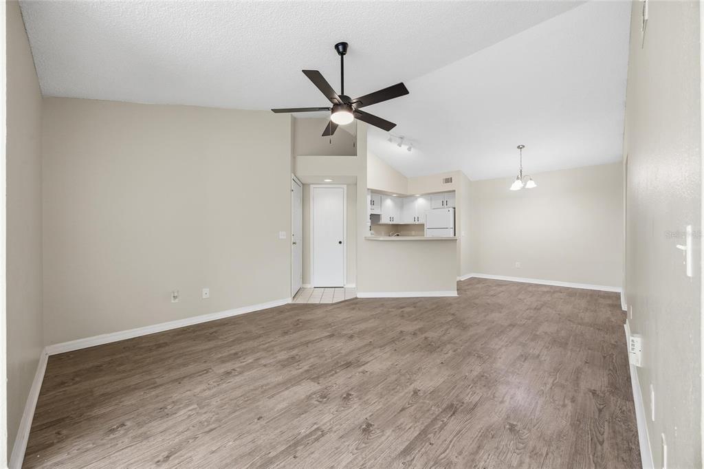 4532 Commander Drive, Unit 2132 Orlando, FL 32822 - Photo 7 of 26 a view of a kitchen with a sink and a refrigerator