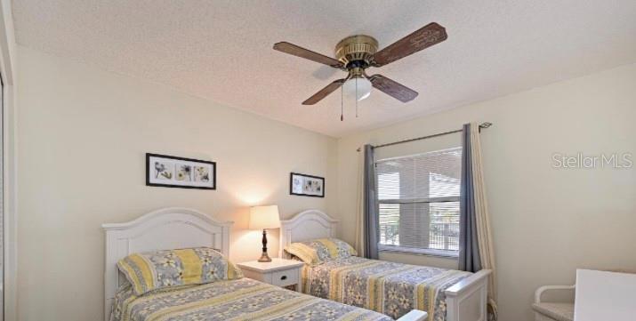 6501 Stone River Road, Unit 303 Bradenton, FL 34203 - Photo 11 of 30 a bedroom with a bed and wooden floor