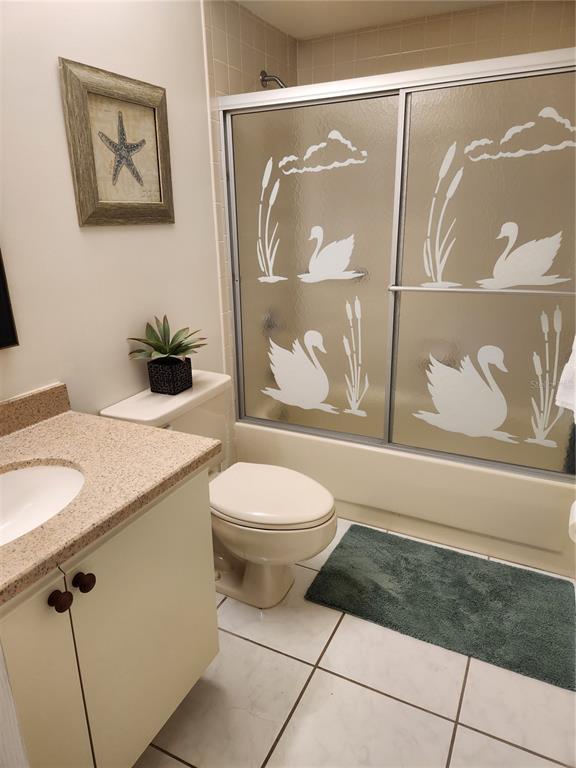 6501 Stone River Road, Unit 303 Bradenton, FL 34203 - Photo 12 of 30 a bathroom with a granite countertop sink mirror vanity and toilet