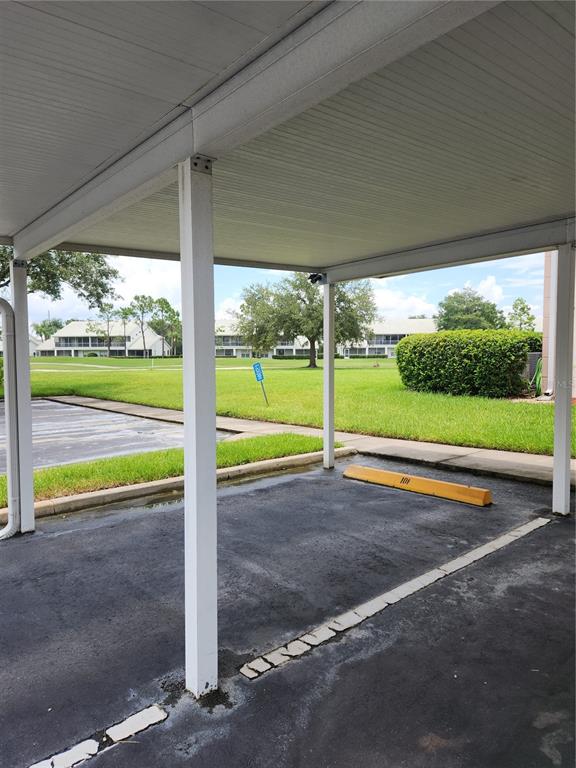 6501 Stone River Road, Unit 303 Bradenton, FL 34203 - Photo 18 of 30 a view of a room with table and chairs in front of it with a small yard