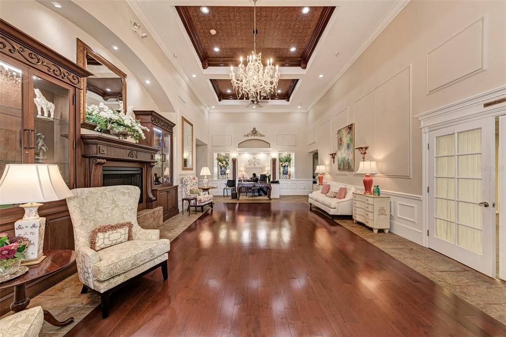 6501 Stone River Road, Unit 303 Bradenton, FL 34203 - Photo 24 of 30 a living room with fireplace furniture and a chandelier