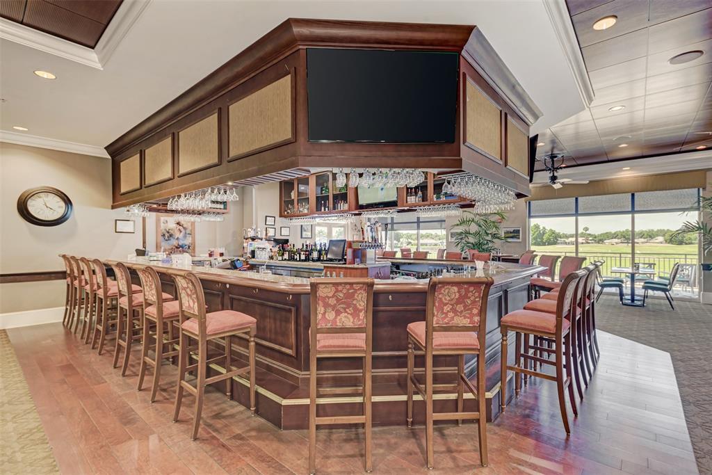 6501 Stone River Road, Unit 303 Bradenton, FL 34203 - Photo 26 of 30 a dining room with stainless steel appliances kitchen island granite countertop a table and chairs