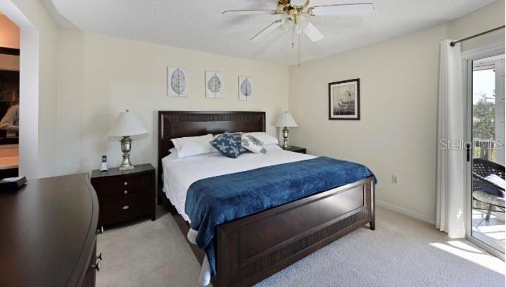 6501 Stone River Road, Unit 303 Bradenton, FL 34203 - Photo 7 of 30 a bedroom with a bed and a chandelier