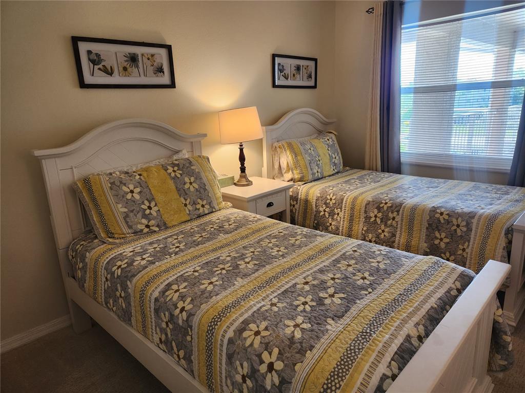6501 Stone River Road, Unit 303 Bradenton, FL 34203 - Photo 10 of 30 a bedroom with two beds and a large window