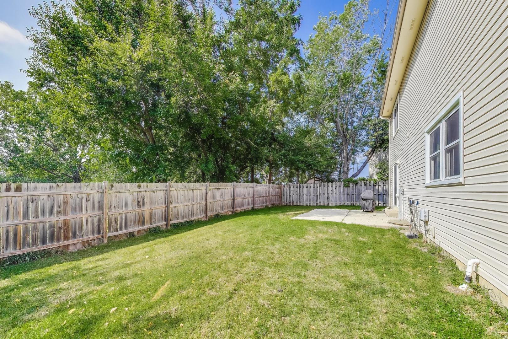 5370 Sequoia Court Gurnee, IL 60031 - Photo 24 of 29 a view of a backyard with a small cabin and wooden fence