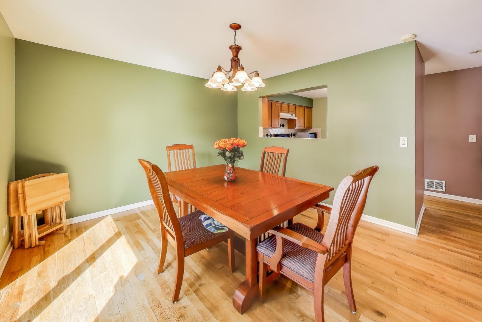 5370 Sequoia Court Gurnee, IL 60031 - Photo 6 of 29 a dining room with furniture and a chandelier