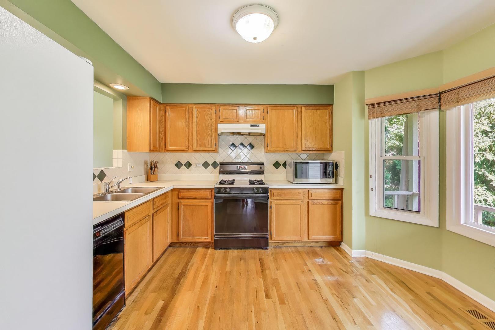 5370 Sequoia Court Gurnee, IL 60031 - Photo 7 of 29 a kitchen with stainless steel appliances a stove sink and cabinets