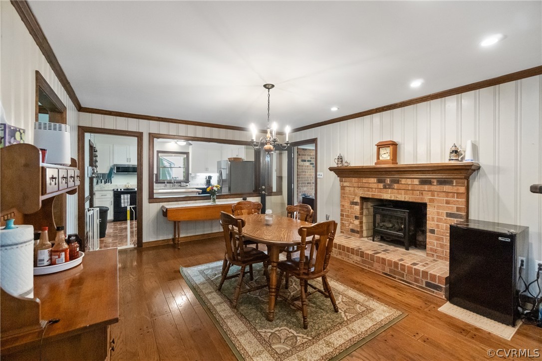 3506 Ludgate Road Chester, VA 23831 - Photo 8 of 22 a dining room with furniture a fireplace and wooden floor