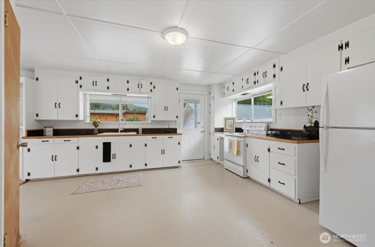 23746 Old Day Creek Road, Unit A & B Sedro-Woolley, WA 98284 - Photo 11 of 36 a large white kitchen with cabinets and white appliances