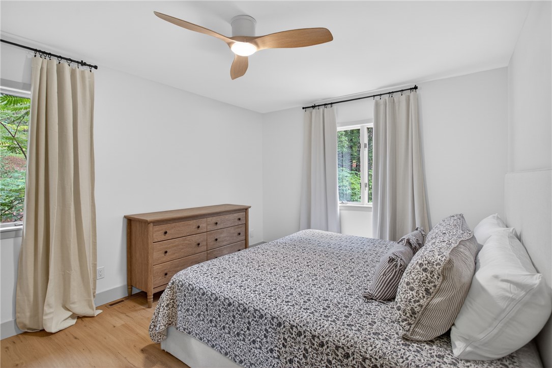 304 Lakeside Drive Seneca, SC 29672 - Photo 33 of 49 Hardwood floors and generous window light create a peaceful bedroom retreat.