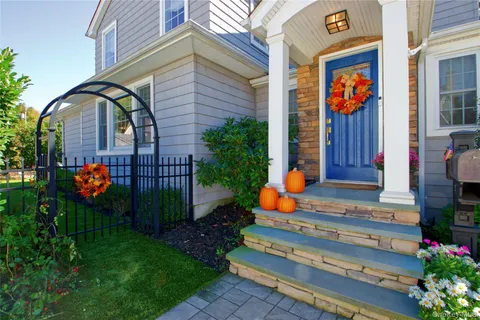 a front view of a house with a yard and fountain