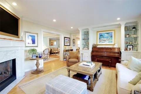 a view of a dining room with furniture large window and wooden floor