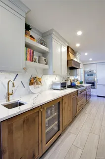a kitchen with a sink a refrigerator and cabinets