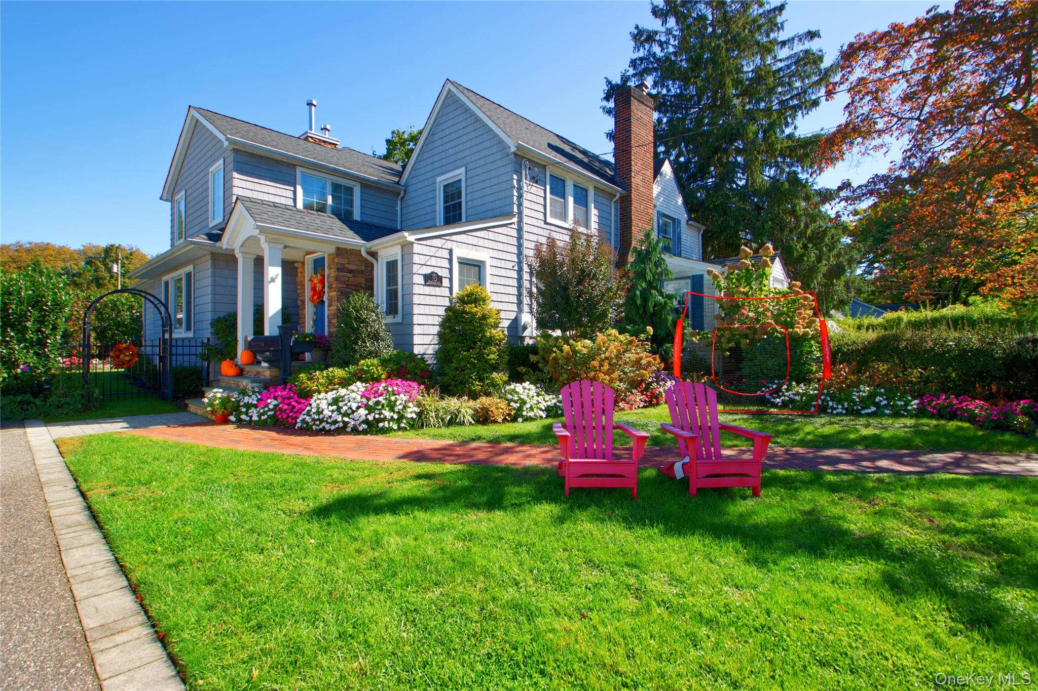 112 Bromleigh Road Garden City, NY 11530 - Photo 2 of 39 a front view of a house with a yard and fountain