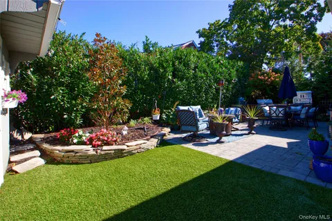 a view of a house with a yard and garden