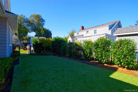 a view of a patio with table and chairs potted plants and a palm tree