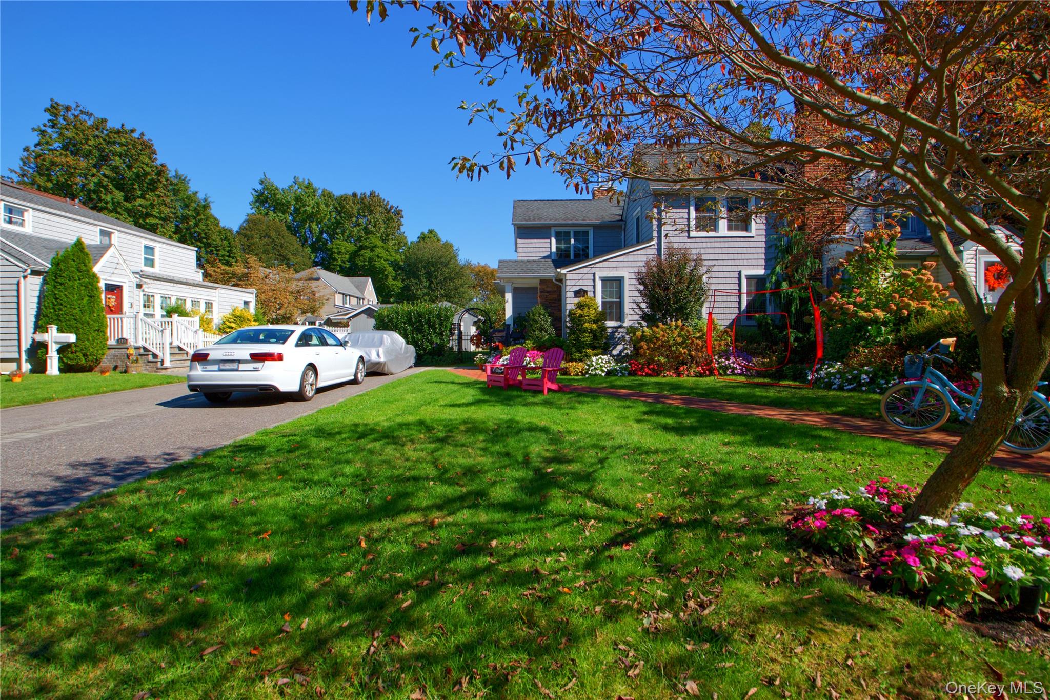 112 Bromleigh Road Garden City, NY 11530 - Photo 4 of 39 a front view of a house with a yard and a large tree