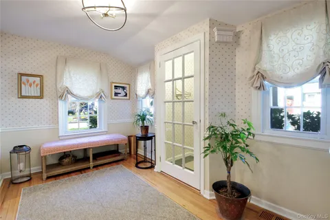 a living room with furniture gym equipment and a window
