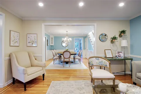 a view of a dining room with furniture and a chandelier