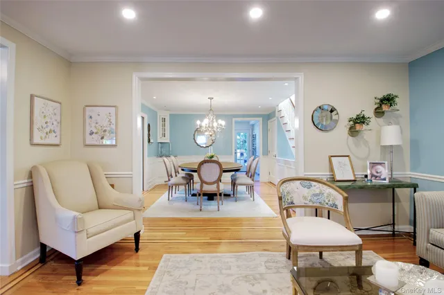 a view of a dining room with furniture and a chandelier