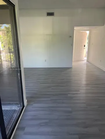 an empty room with wooden floor