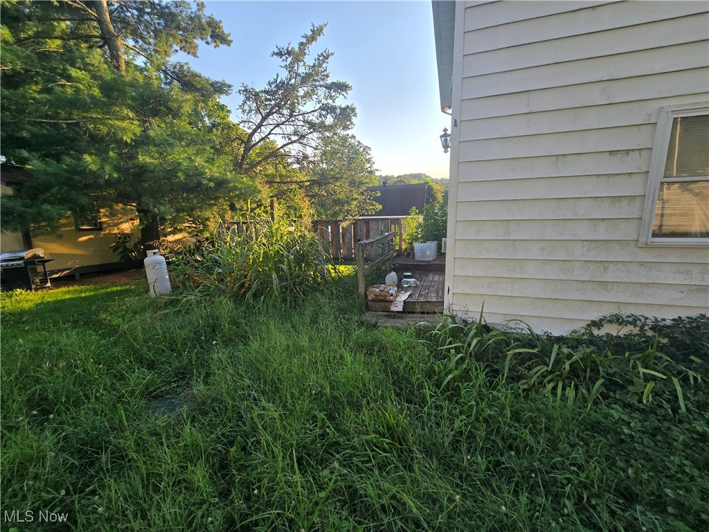 73 Locust Rutland, OH 45775 - Photo 2 of 4 View of side of property with a wooden deck