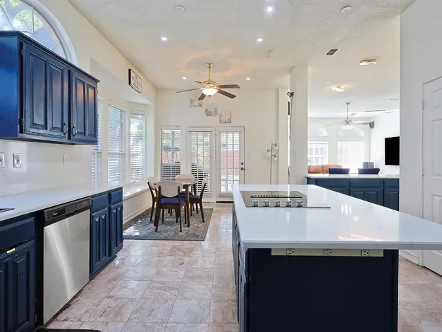 a bathroom with a granite countertop sink mirror vanity and toilet