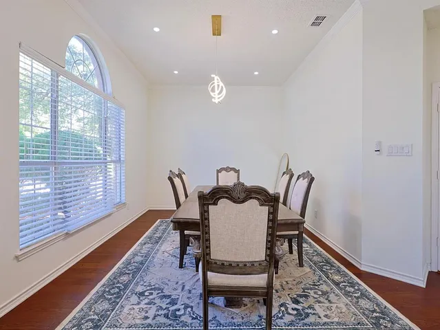 a view of a dining room with furniture wooden floor and a rug