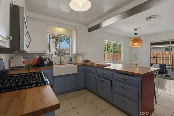a kitchen with stainless steel appliances granite countertop a sink stove and cabinets