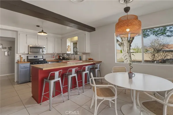 a kitchen with stainless steel appliances a sink a counter top space cabinets and wooden floor