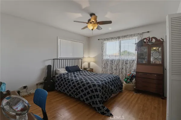 a bedroom with a bed and wooden floor