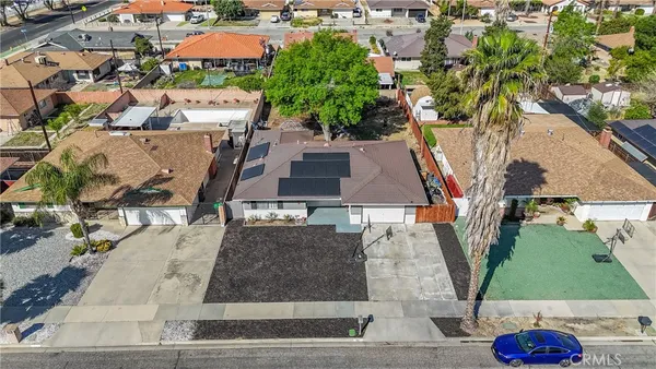 an aerial view of a house with a yard