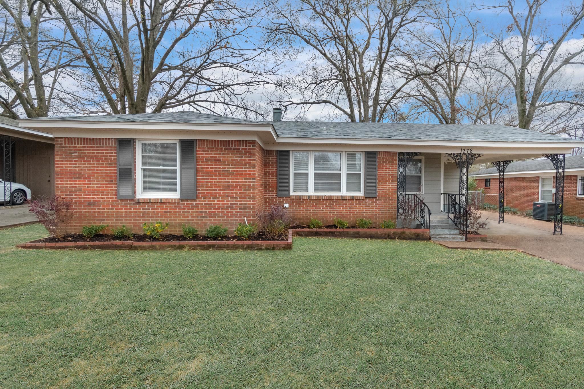 1378 Woodston Road Memphis, TN 38117 - Photo 1 of 19 a front view of house with yard and seating space