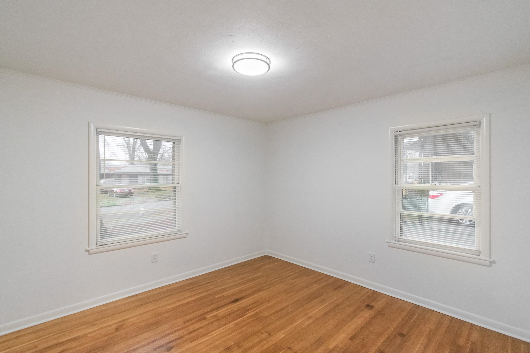 1378 Woodston Road Memphis, TN 38117 - Photo 13 of 19 an empty room with wooden floor and windows