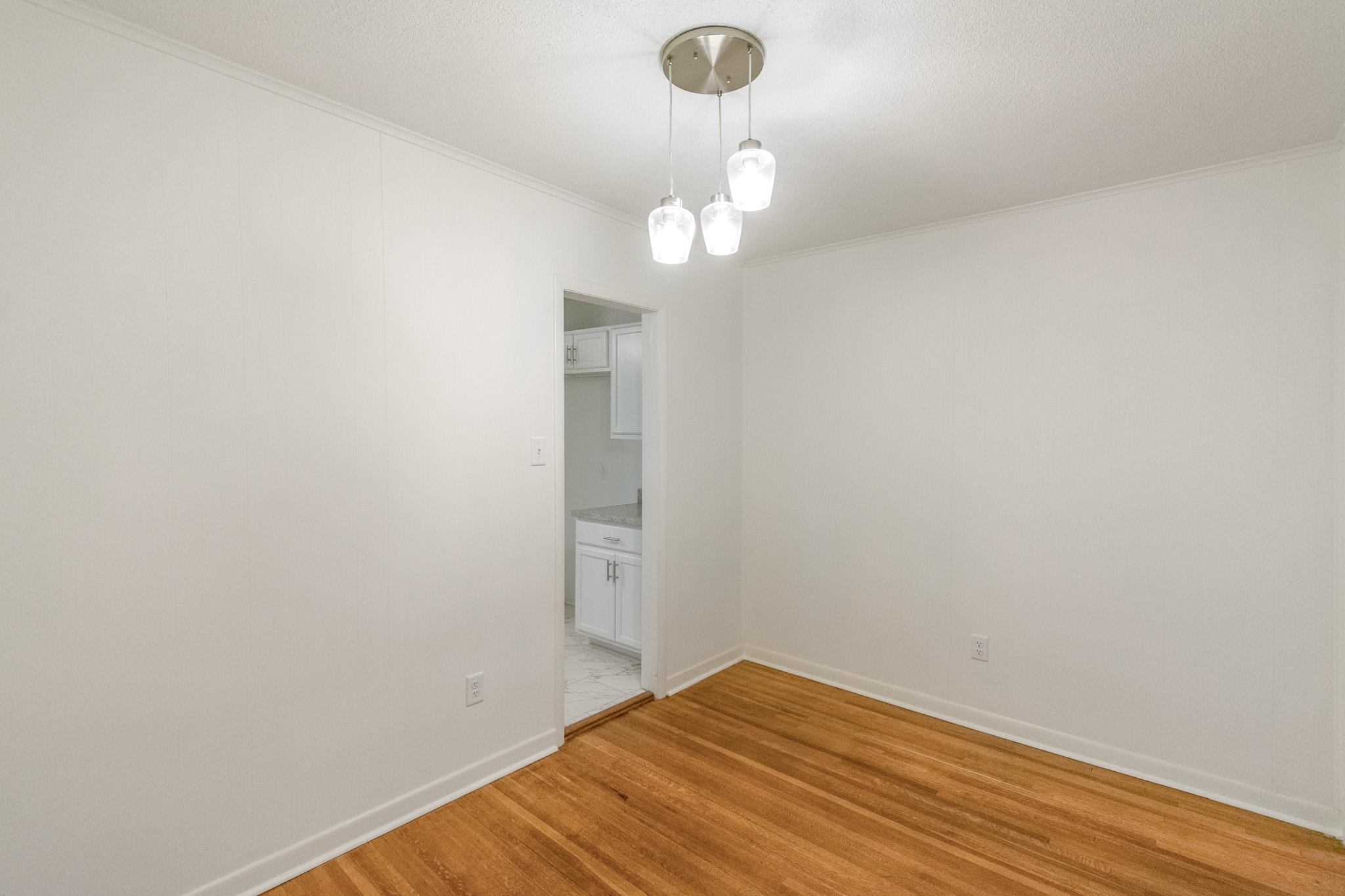 1378 Woodston Road Memphis, TN 38117 - Photo 14 of 19 a view of a room with wooden floor and white walls