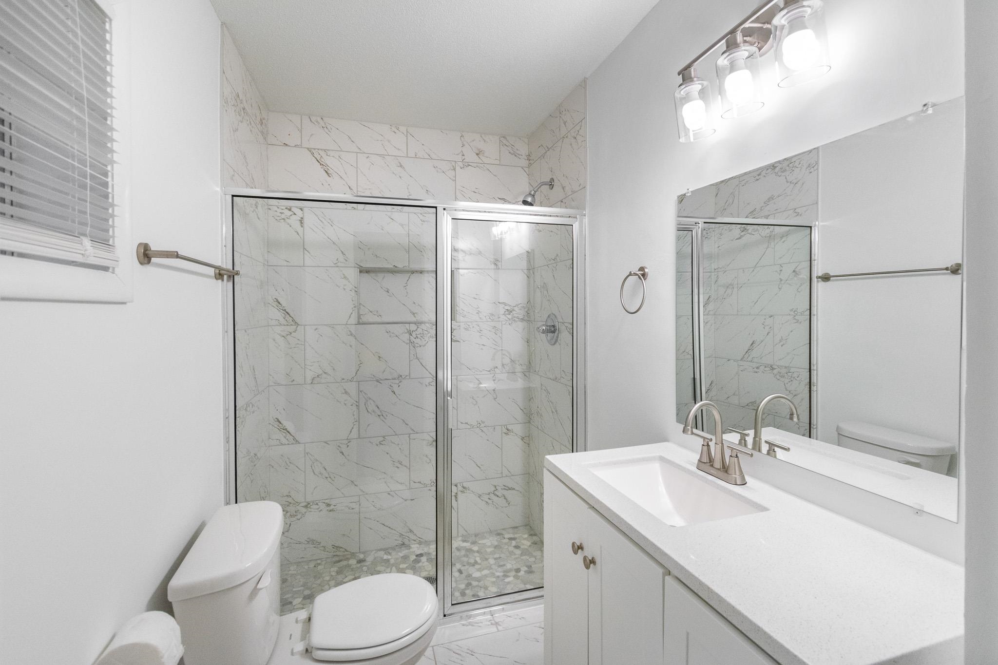 1378 Woodston Road Memphis, TN 38117 - Photo 15 of 19 a bathroom with a sink toilet and shower