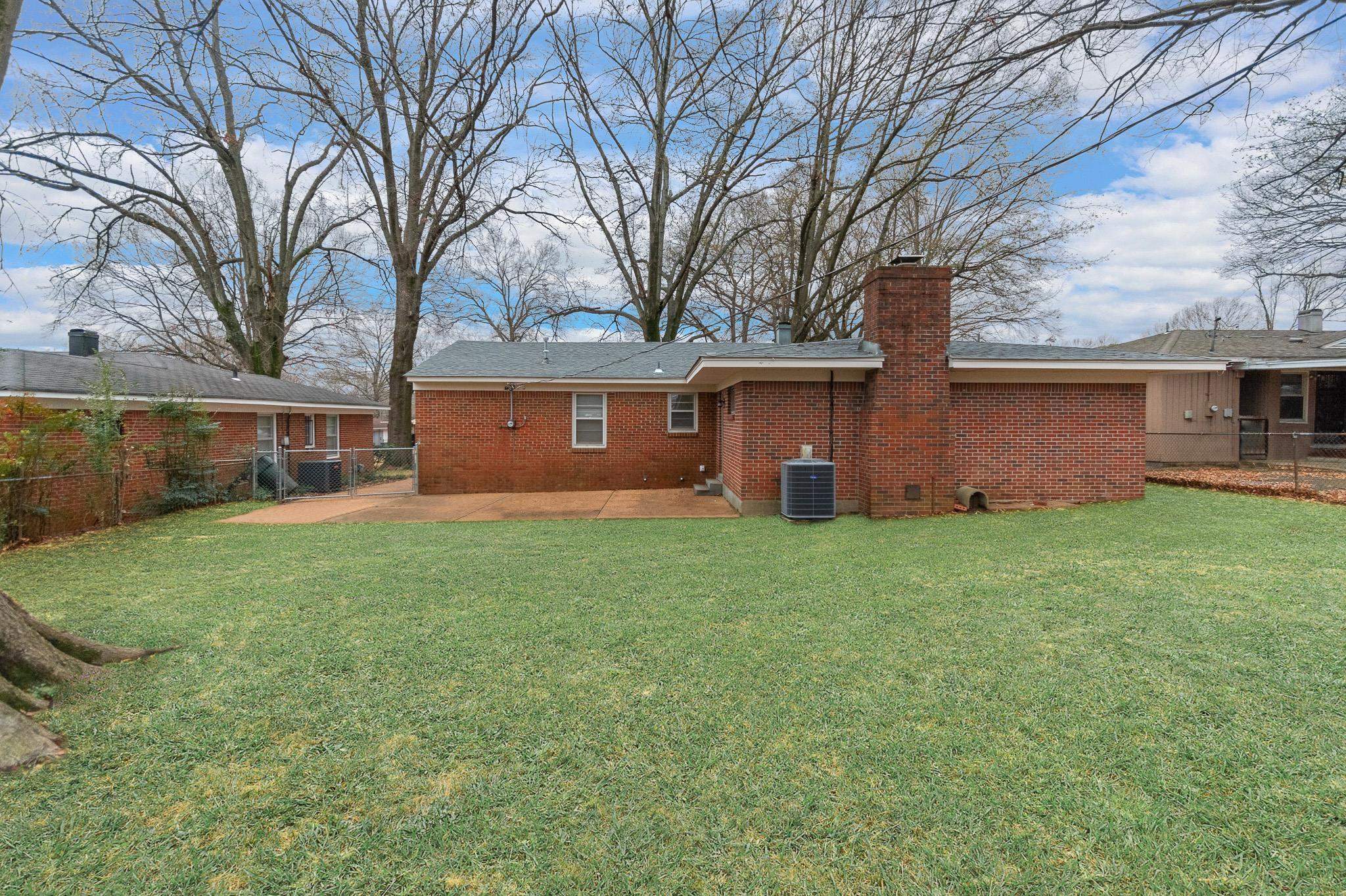 1378 Woodston Road Memphis, TN 38117 - Photo 17 of 19 a view of a house with backyard and a tree