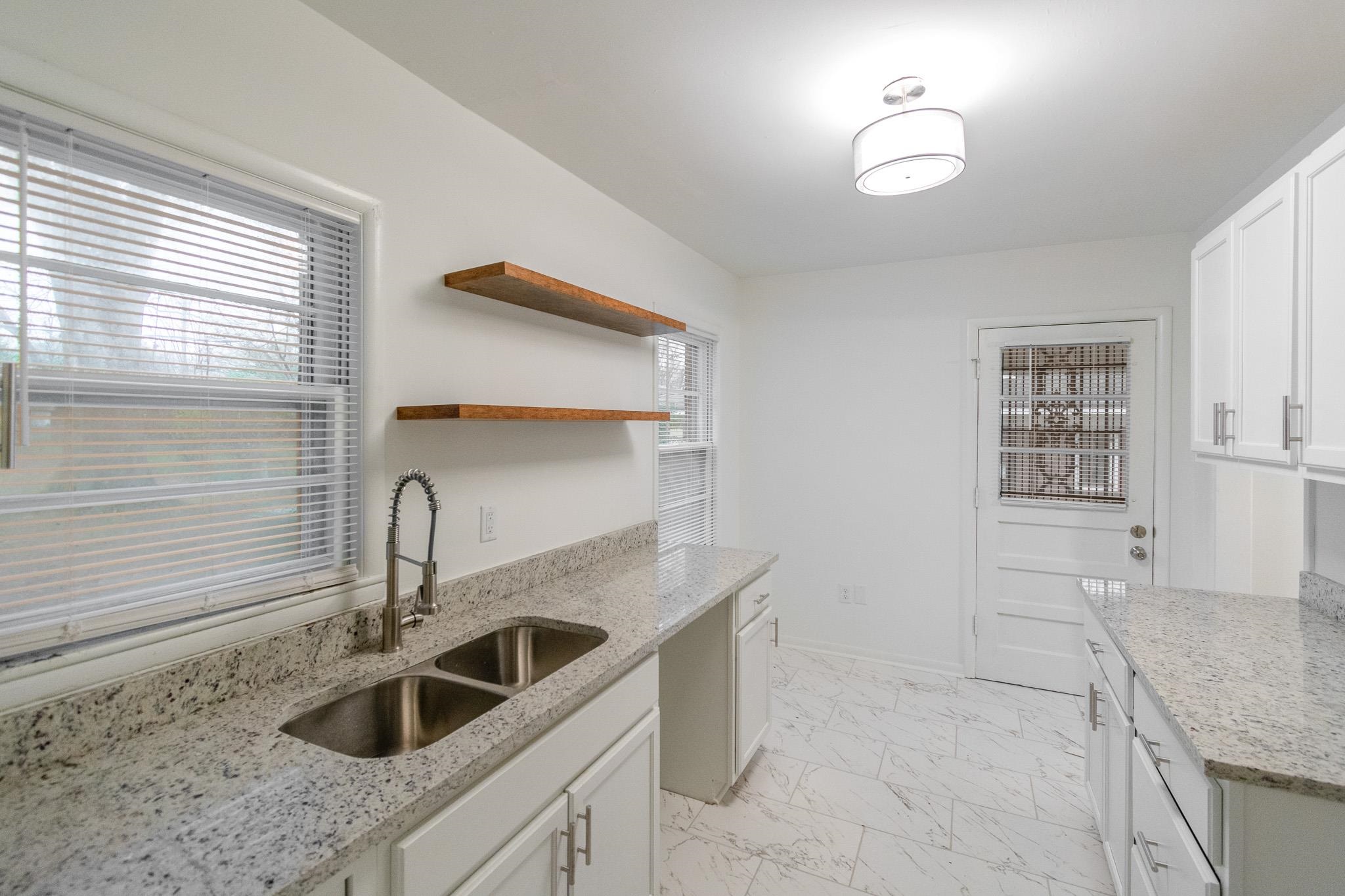 1378 Woodston Road Memphis, TN 38117 - Photo 4 of 19 a kitchen with a sink and cabinets