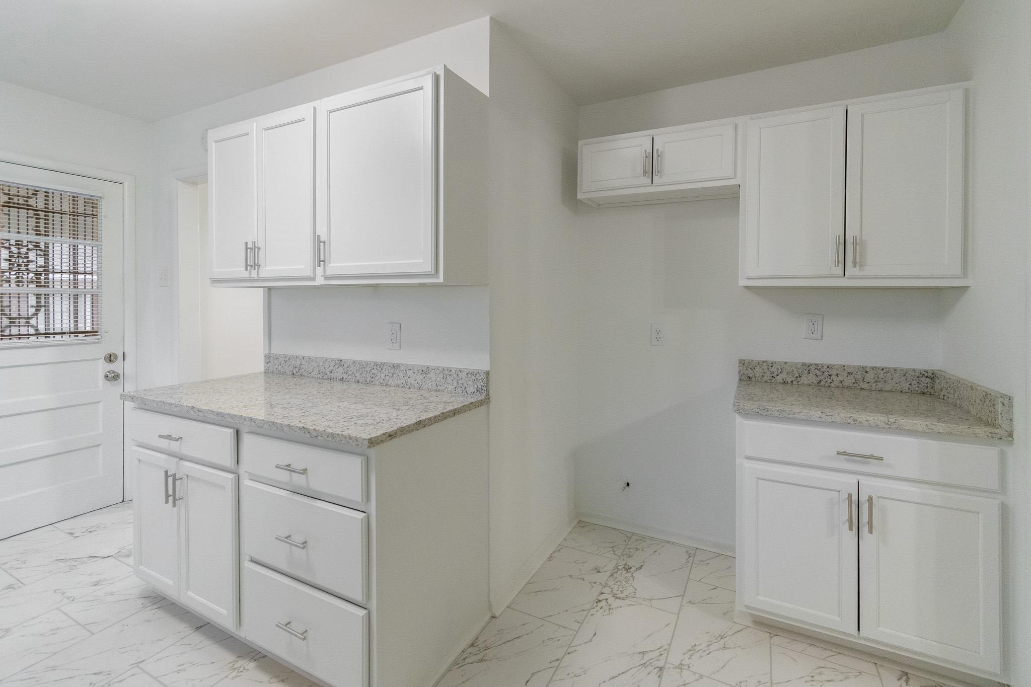 1378 Woodston Road Memphis, TN 38117 - Photo 6 of 19 a kitchen with granite countertop white cabinets and a sink