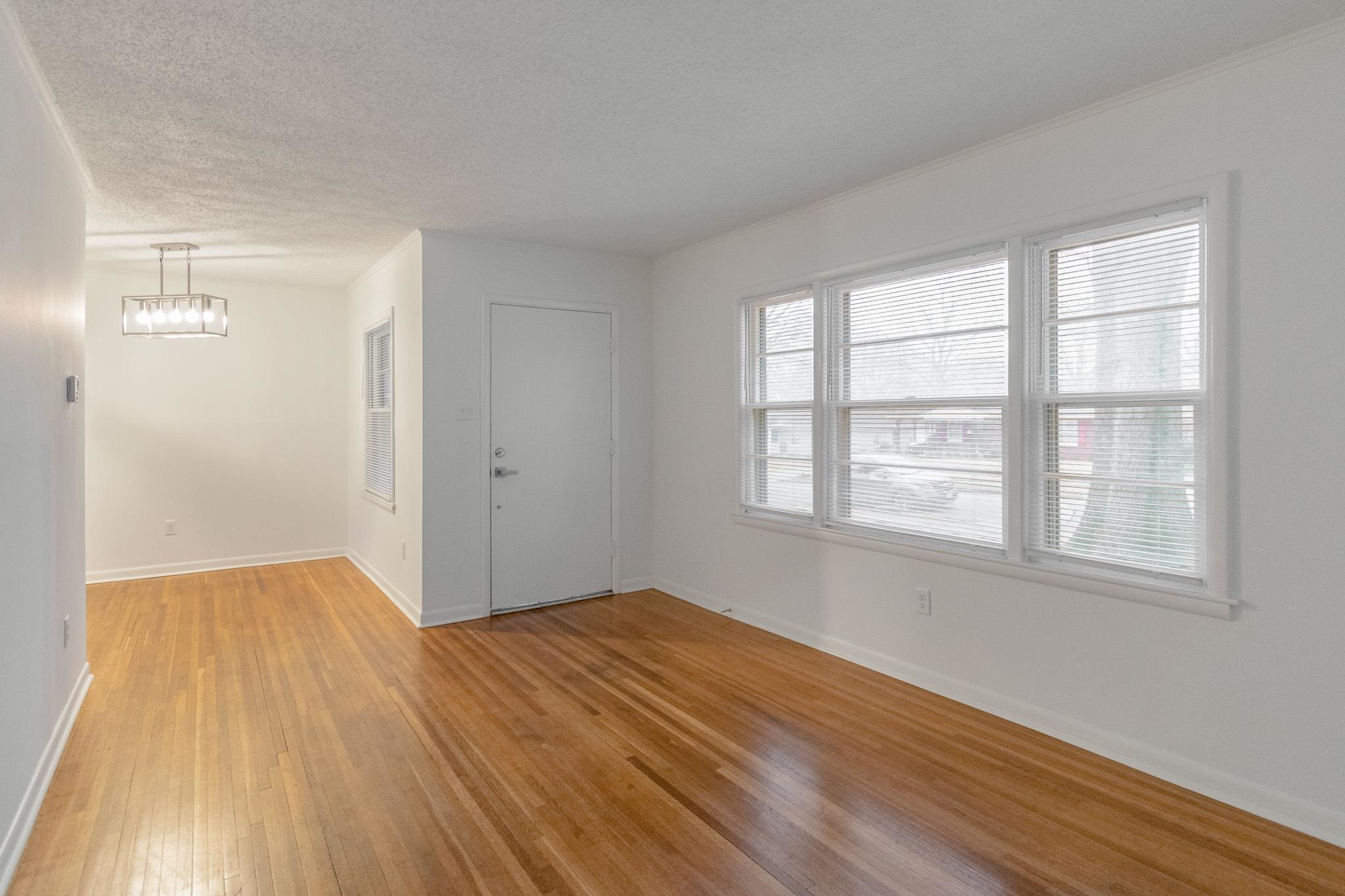 1378 Woodston Road Memphis, TN 38117 - Photo 7 of 19 an empty room with wooden floor and windows