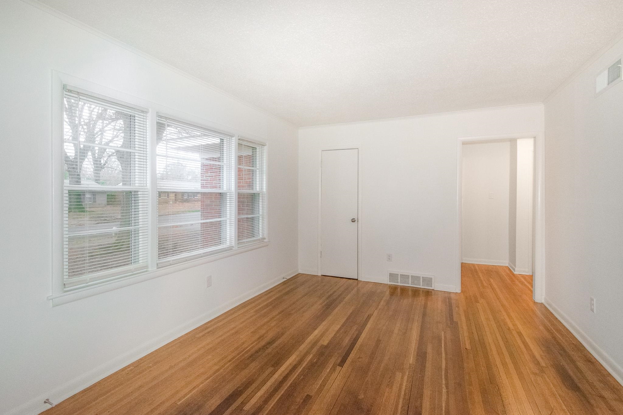 1378 Woodston Road Memphis, TN 38117 - Photo 8 of 19 a view of empty room with wooden floor and fan