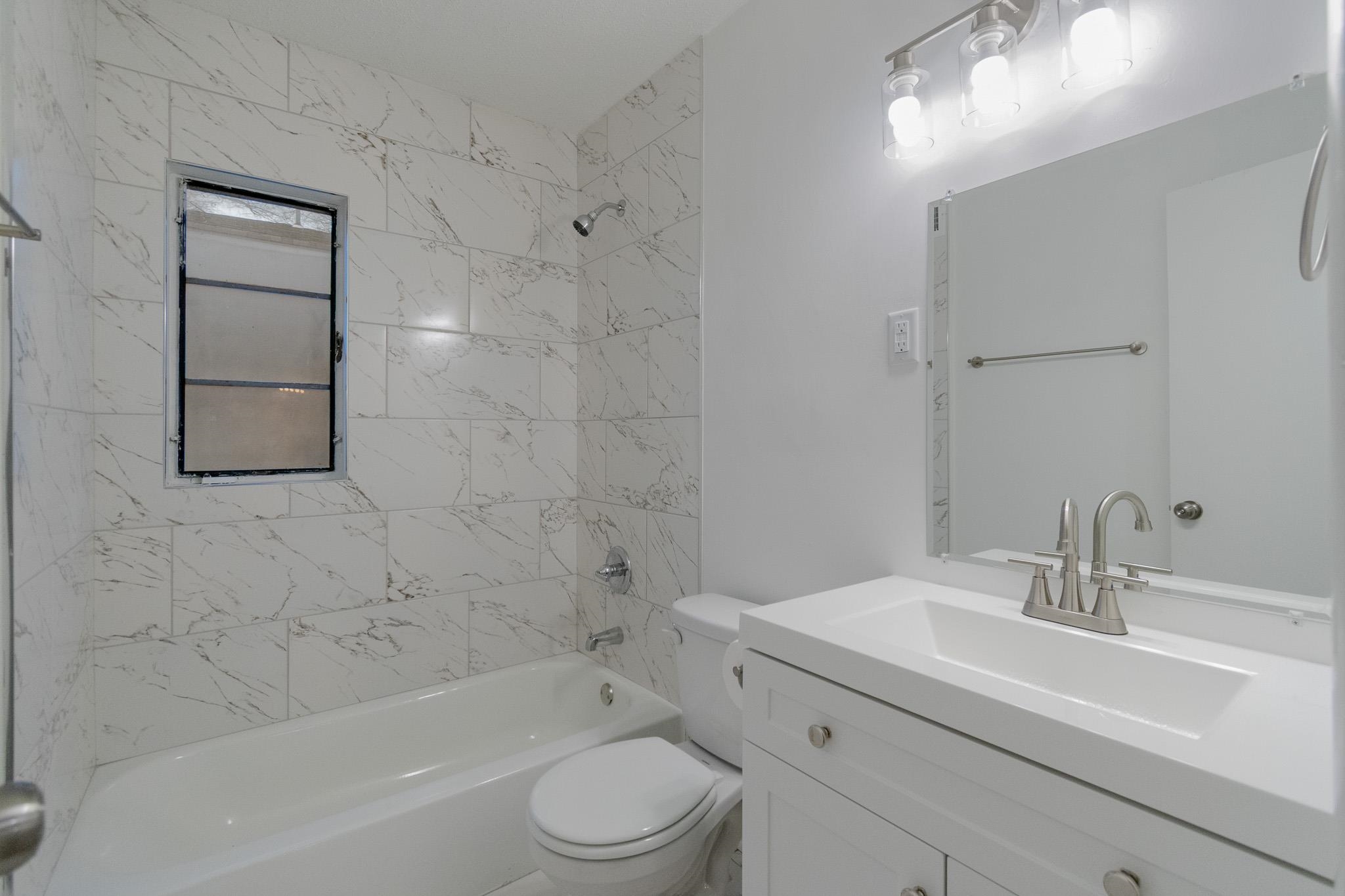 1378 Woodston Road Memphis, TN 38117 - Photo 10 of 19 a bathroom with a sink a toilet and shower