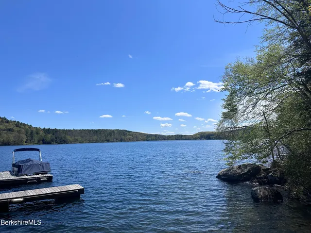 a view of a lake with chairs