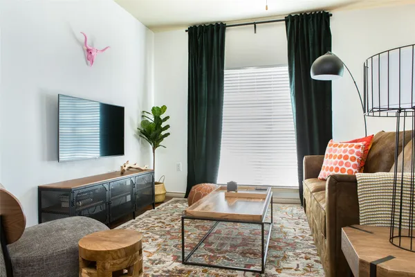 a living room with furniture and a potted plant