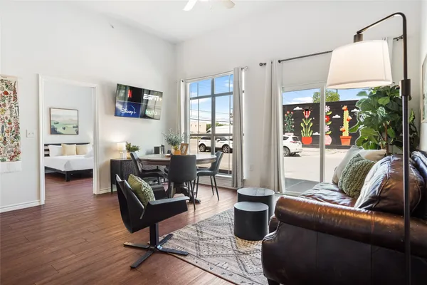 a living room with furniture a lamp and a table