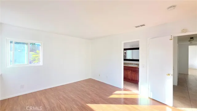 a view of wooden floor and windows in a room