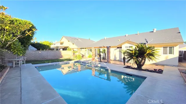 swimming pool view with a seating space