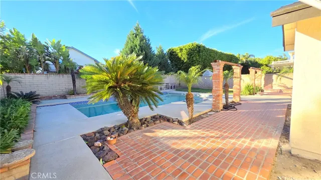 a view of a backyard patio and swimming pool